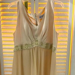 Stunning long ivory colored embellished formal dress for formal occasions.
